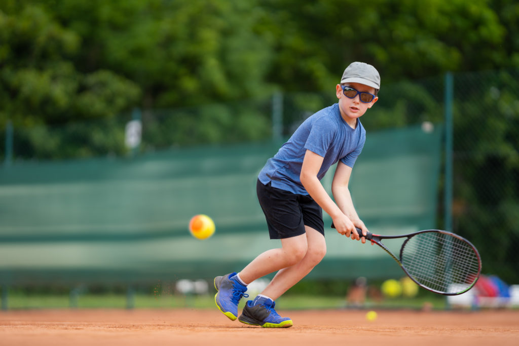 boy playing tennis