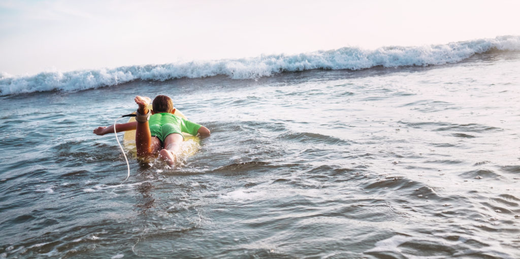 boy floats on surf boards