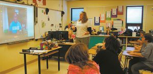 Teacher Michelle Munro introduces her Grade 6 students to Canadian sprinter Sam Effah via Internet link on Monday morning. The Grade 5 classroom in the school also viewed the interchange between the sprinter and the Grade 6 students. ©ProvoST NEwS PhoTo.